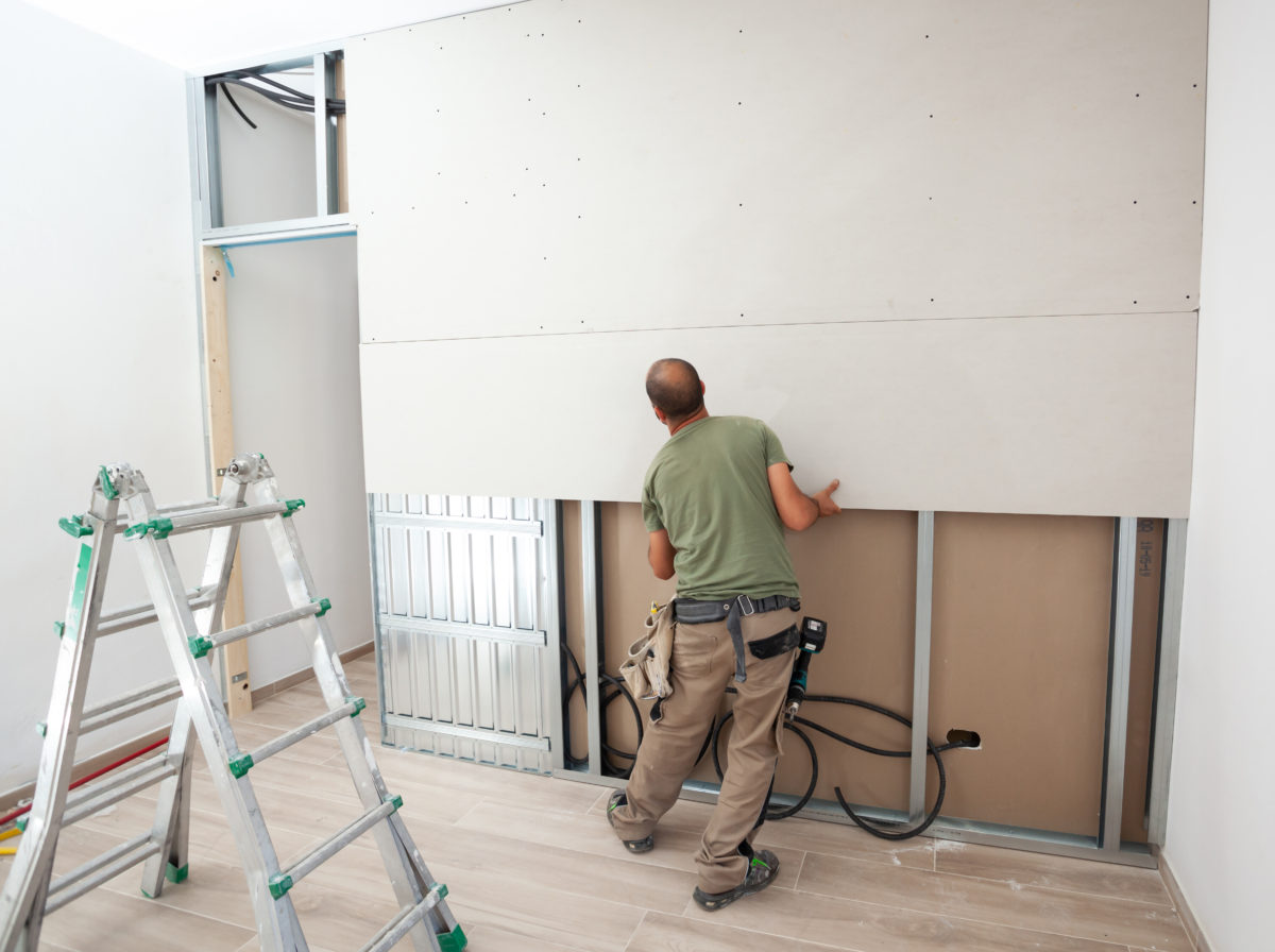 worker-building-plasterboard-wall-aevd2r7-1200x896